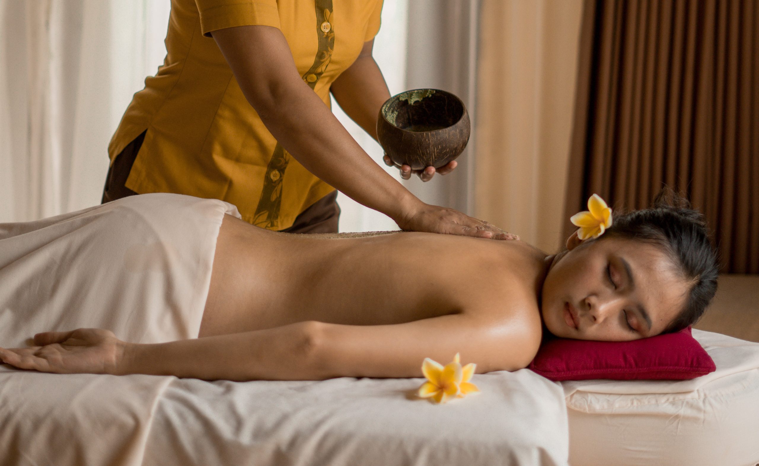 Herbal oil massage with frangipani flowers